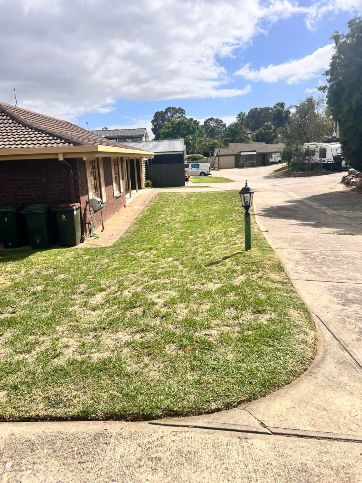 Front yard lawn cut clean to the driveway edge